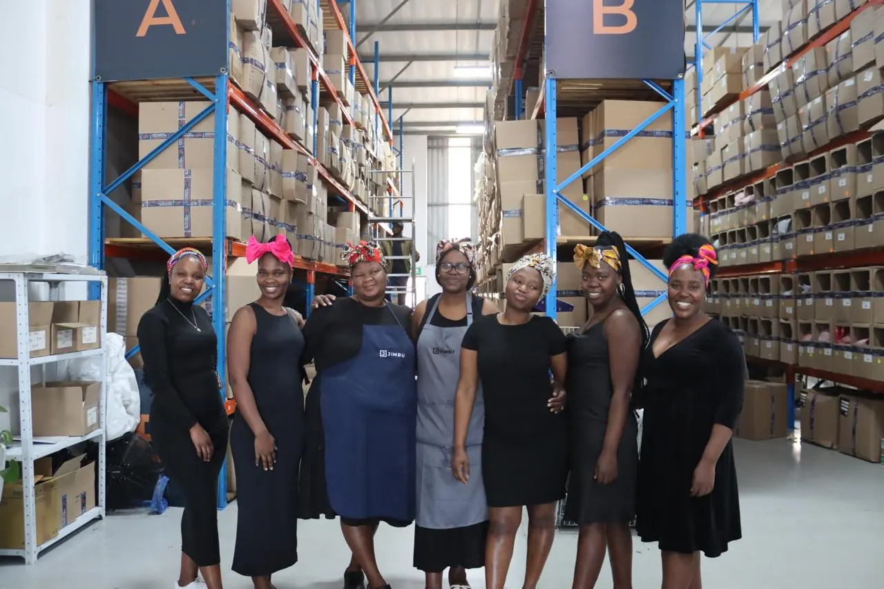 JIMBU team members standing together in the JIMBU warehouse