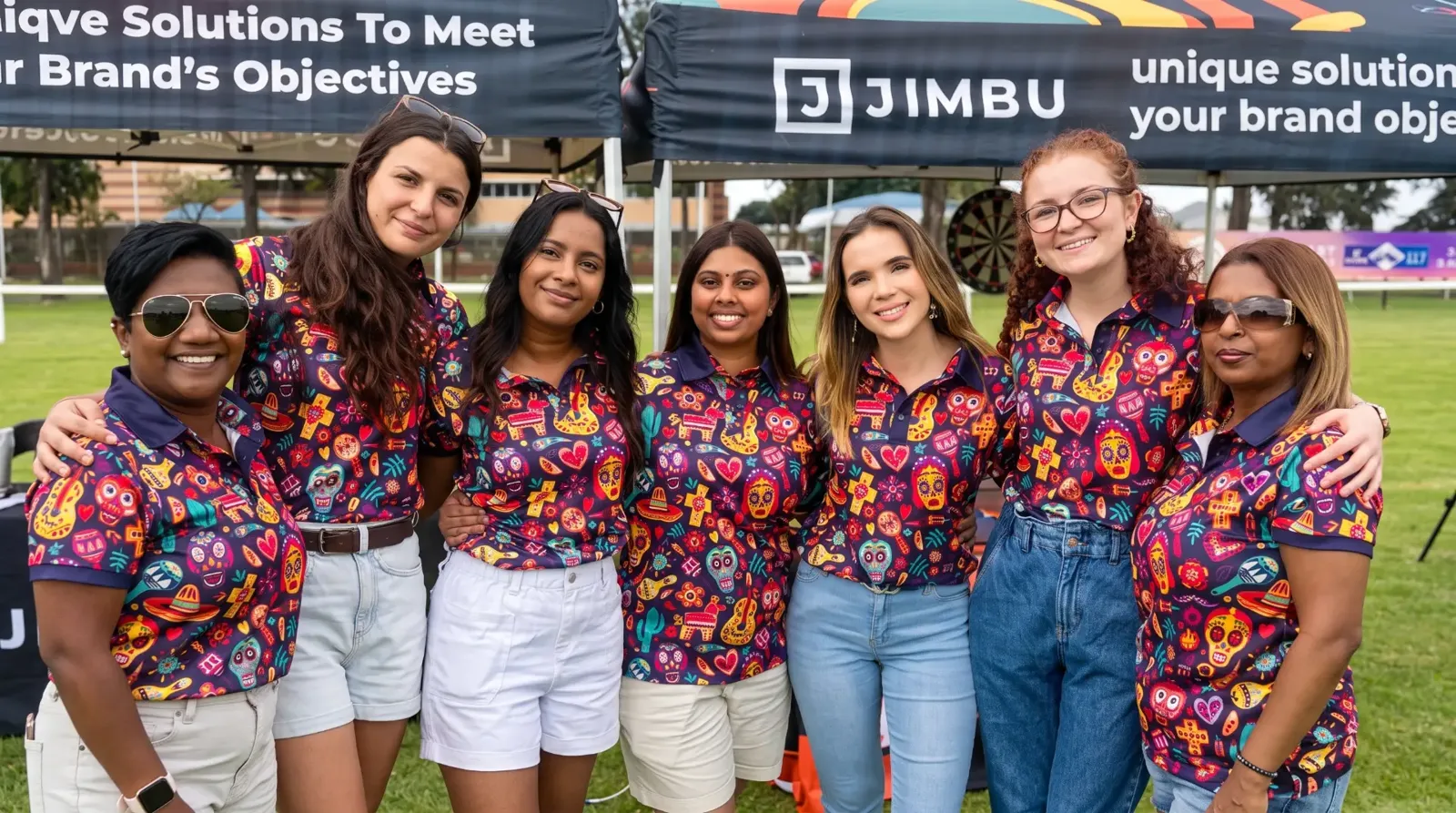 JIMBU account managers in matching printed shirts at a JIMBU event gazebo