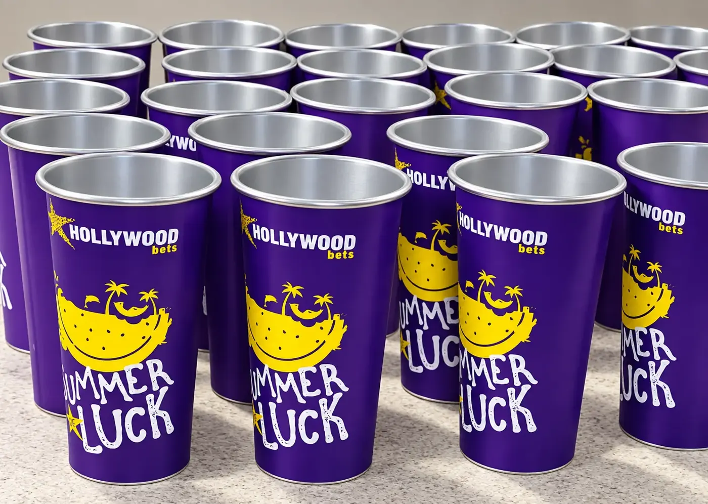 Rows of purple Hollywoodbets Summer of Luck branded metal cups