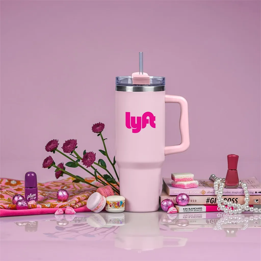 Pink Lyft branded tumbler with handle and straw